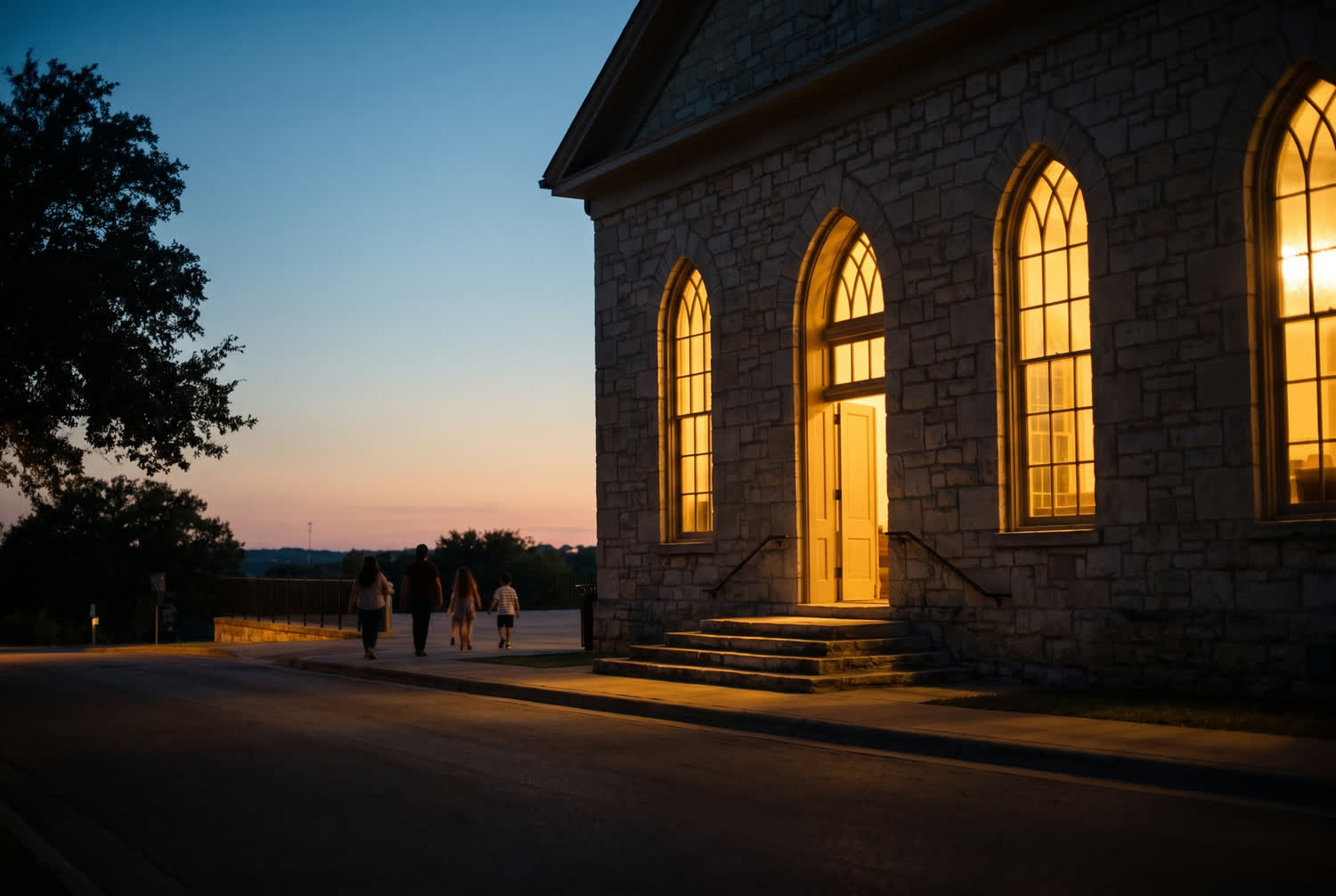An old stone chapel hall at dusk, warm light in the arched windows, people arriving in the distance.